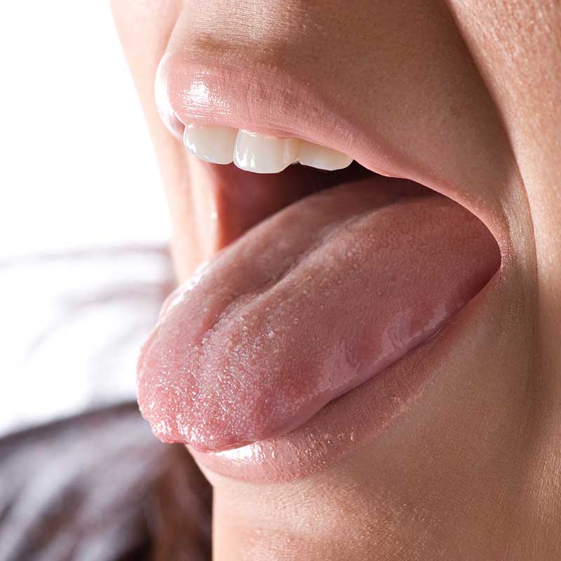 closeup-of-a-young-woman-sticking-out-her-tongue_HF_e2XuRHi
