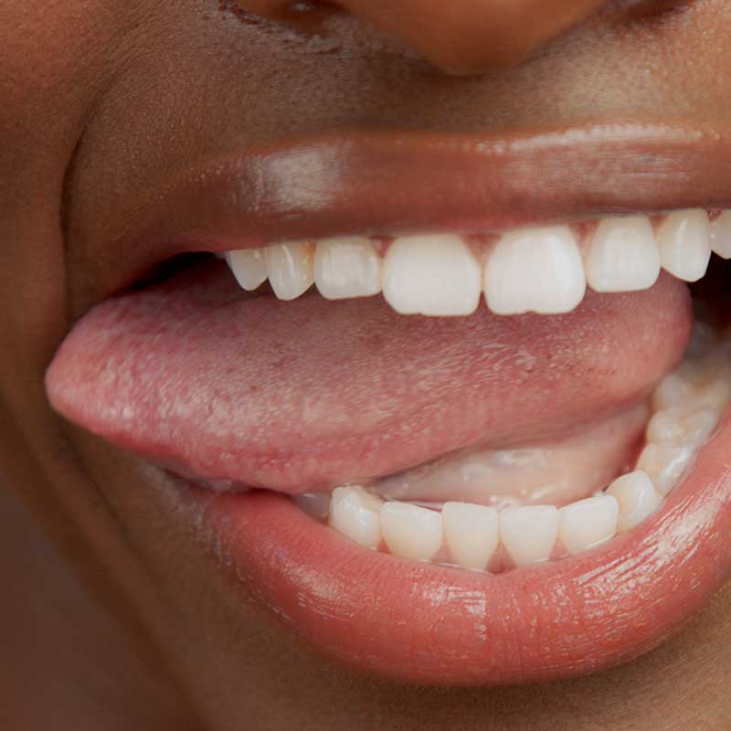 storyblocks-closeup-shoot-of-black-womans-mouth-with-tongue-out_S4zz5DcO4N